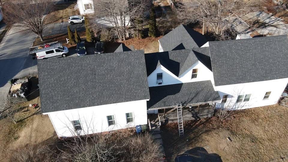 Aerial view of completed home with new architectural asphalt shingle roof