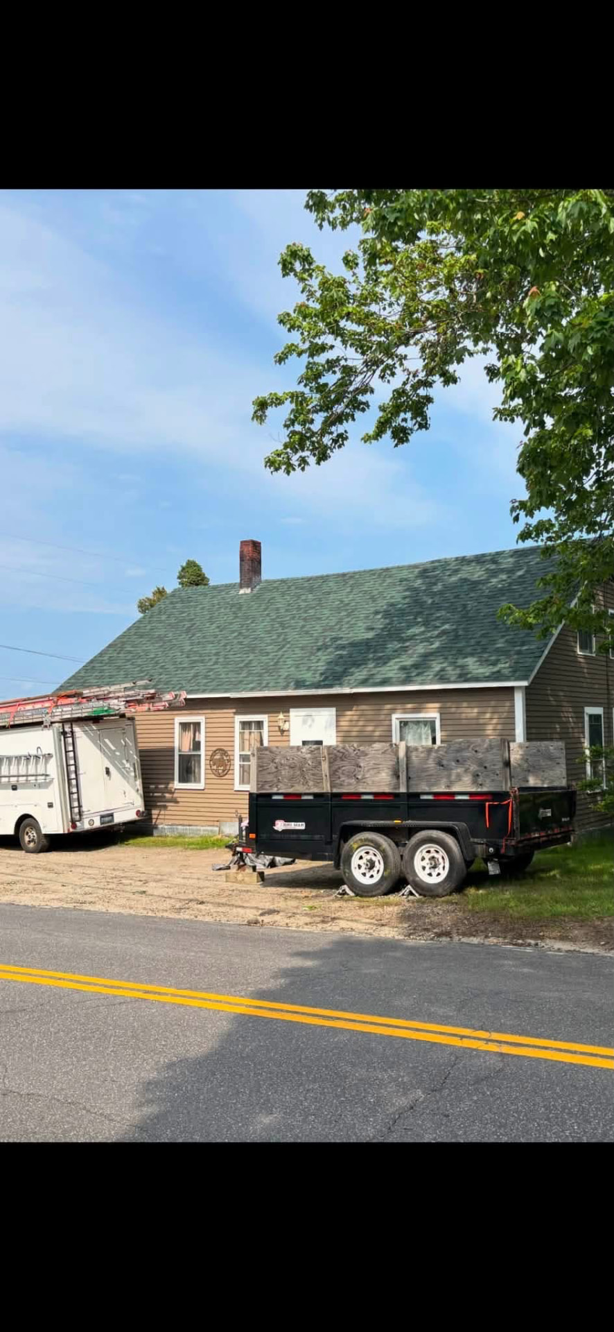 Residential home with dump trailer during exterior project