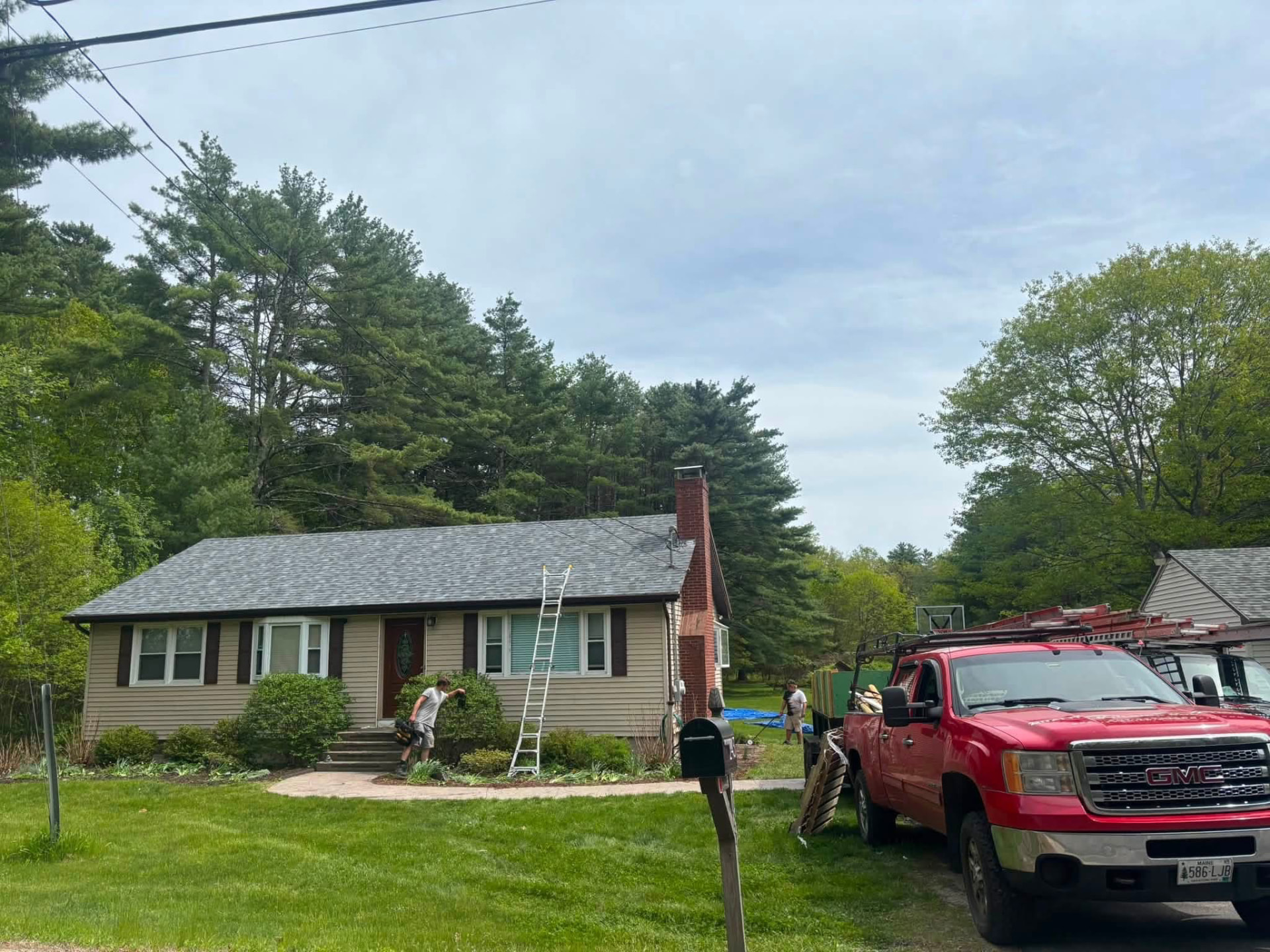 Beautiful residential home exterior with new siding, roof, and trim in Maine