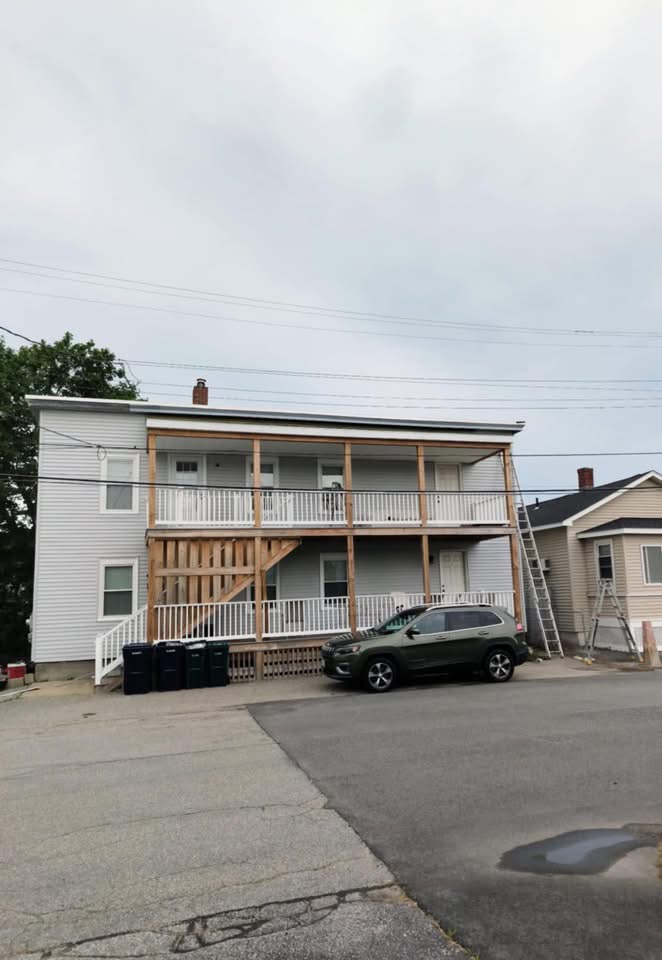 Multi-unit home mid-project with framed porches and partial siding